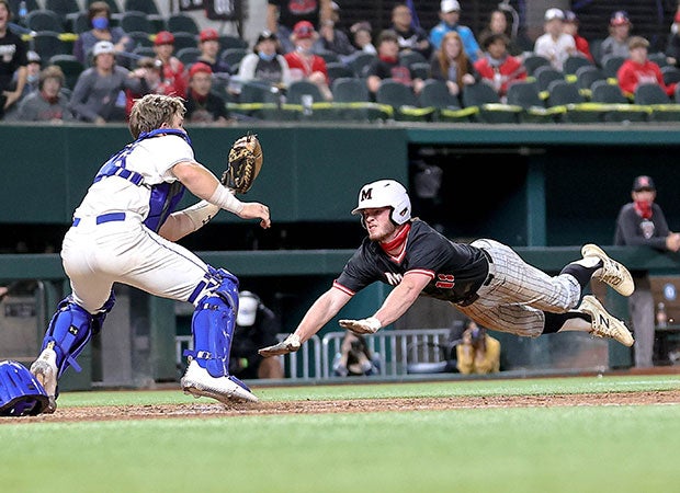 IMG Academy (Fla.) catcher Brady Neal awaits the throw as Marcus baserunner Wesley Jordan attempts to steal home after the ball was returned to the pitcher during the Dragon Classic at Globe Life Field in Arlington, Texas. He was out at home plate.  