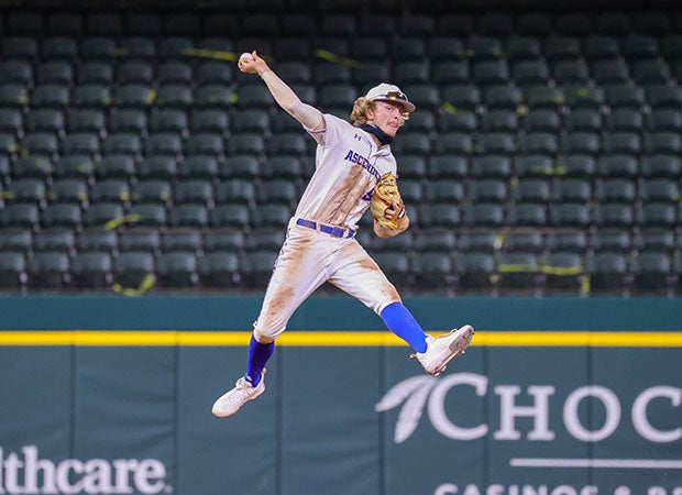 IMG Academy (Fla.) second baseman Drake Varnado makes a leaping throw to first base during game against Marcus in the Dragon Classic at Globe Life Field in Arlington, Texas.