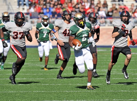 Dontre Wilson (2) runs past the Coppell defense en route to a 204-yard rushing game in DeSoto's surprising 42-14 5A Texas playoff win in a battle of nationally ranked teams. 