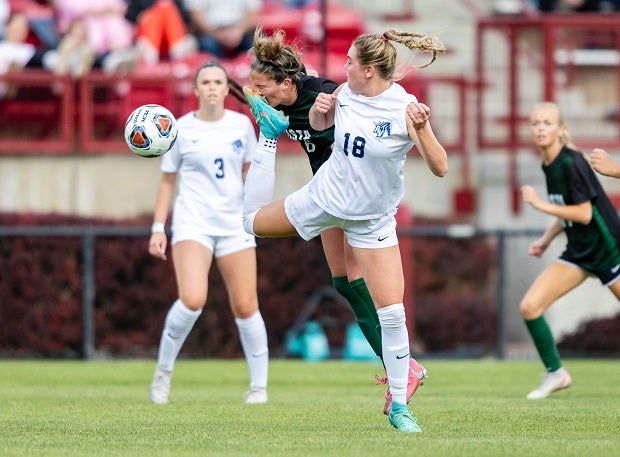 Mountain Vista senior Riley MacDonald gets a high kick to the nose from Ralston Valley junior Holly Engelking in the first half of the CHSAA 5A semifinal game. MacDonald went on to deliver the golden goal in the 99th minute to advance Mountain Vista to the championship game. (Photo: Tim Bourke)