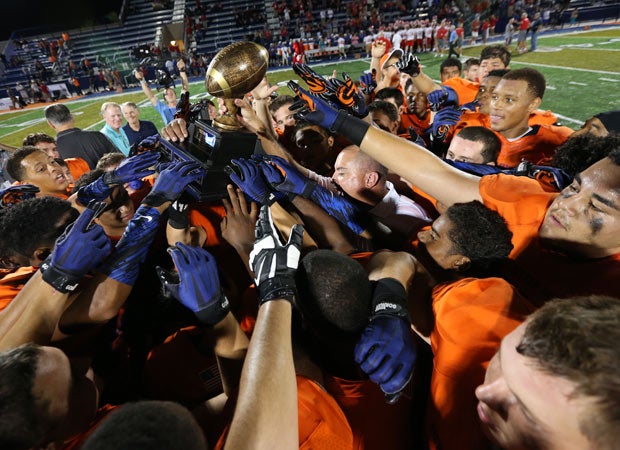Bishop Gorman players celebrate by hoisting the Sollenberger Classic trophy.