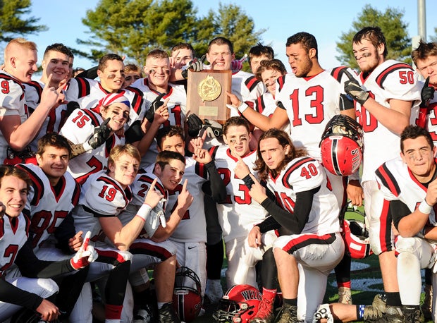 Wells and coach Tim Roche won the 2016 Maine Class C state football championship.