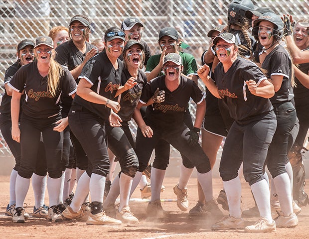 Campo Verde (Ariz.) players excitedly wait at home plate for a teammate to round the bases following a home run in an AIA playoff game against Desert Ridge.
