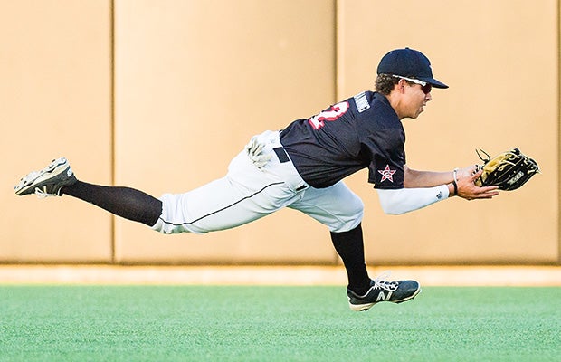 Coppell (Texas) outfielder Ty Manning makes a diving basket catch during a UIL 6A Regional quarterfinal playoff game.