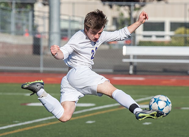 A Sumner (Wash.) player leaps while controlling the ball during a game against host North Thurston.