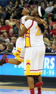 Berkeley's Elisha Davis (left)
jumps into the arms of Khristina
Hunter following final buzzer
of NorCal title win.