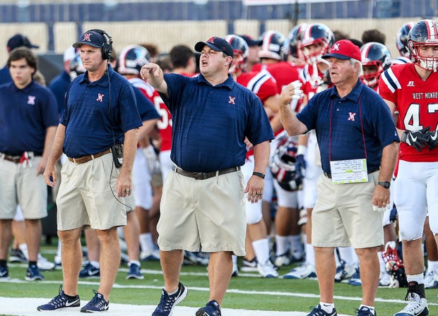 The West Monroe football coaching staff flashes instruction in the 2016 state title game versus John Curtis. 