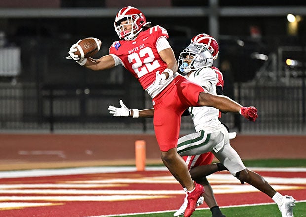 Ace Leutele leaps to make an interception during Mater Dei's state championship game victory over De La Salle. The defensive back was a MaxPreps Freshman All-American and is expected to be a key cog for the Monarchs in 2025. (PHOTO: Heston Quan)