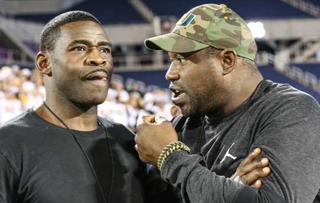 Michael Irvin and Warren Sapp watch St. Thomas Aquinas take on Viera.