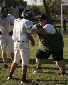 Arnold isn't afraid to give hands-on lessonsto her players. She played parts of sixseasons on the offensive line in semi-professional women's football.