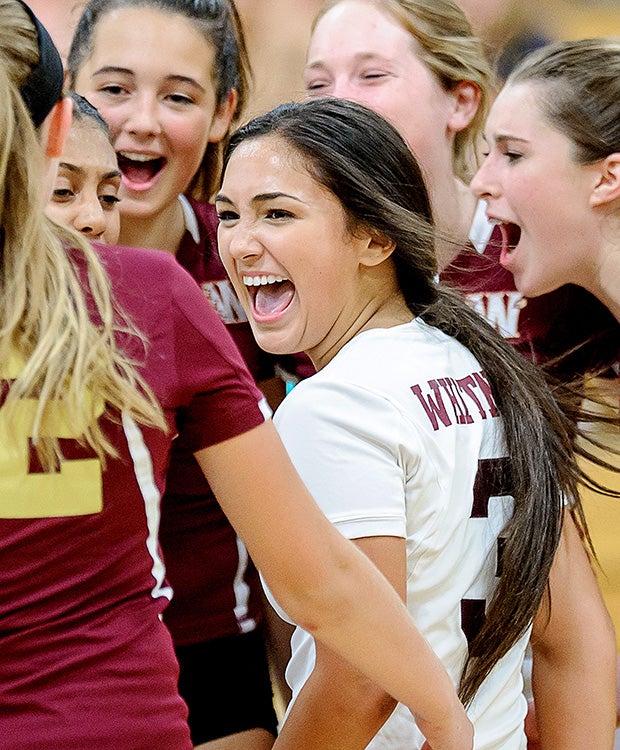 Alexis Padilla (center) of Whitney (Calif.) celebrates with her teammates after a point win against Rocklin in a junior varsity volleyball match.  