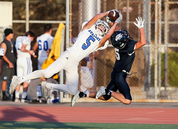 Burbank (Calif.) receiver Ben Burnham makes a leaping catch for a touchdown in front of Crescenta Valley defensive back Sam Kunz during a junior varsity contest.