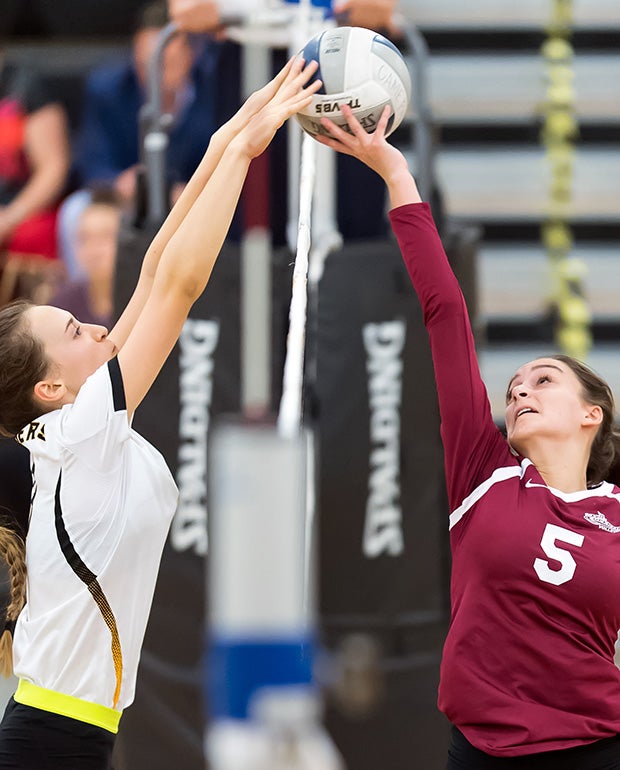 Jevtic Ella (left) of Wilcox (Calif.) and Laura Workman of Cupertino joust at the net during a varsity volleyball match. 