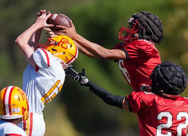 Howard Forehan (right) of San Lorenzo Valley (Calif.) leaps while making an interception over receiver Freddy Albert of Pacific Grove.   