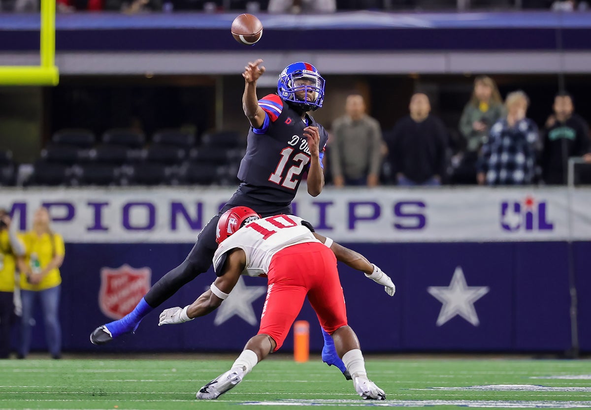 Duncanville sophomore quarterback Keelon Russell hurdles a defender his team's Class 6A Division 1 state championship win over North Shore. (Photo: Robbie Rakestraw)