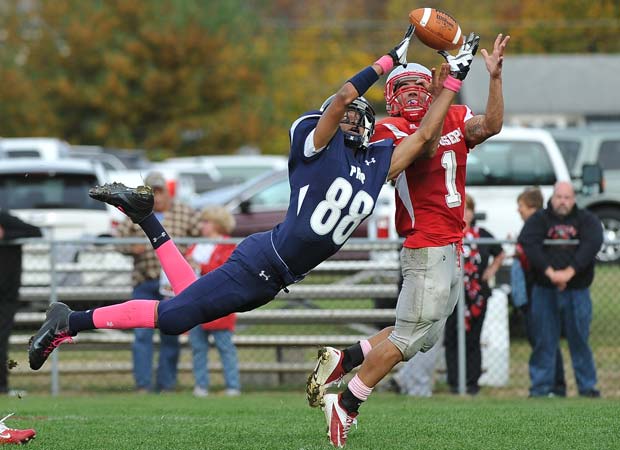 St. Augustine Prep (N.J.) receiver Austin Francisco (left) leaps for a pass in front of St. Joseph defensive back Anthony Giagunto during a game in October.
