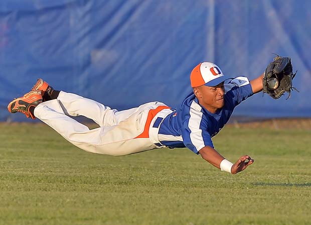 An Osceloa (Fla.) outfielder makes a diving catch during a game against King in the 6A state baseball playoffs in May.