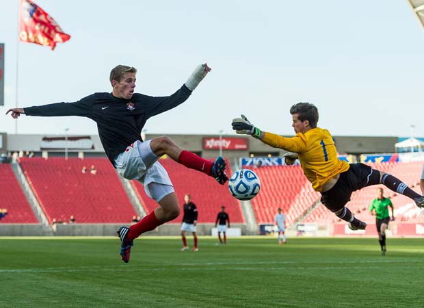 A Bountiful (Utah) goal keeper makes a flying leap in an attempt to deflect a shot by an Orem player during the 4A state title game in May.
