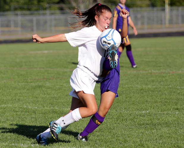 A Noble player (left) battles a Cheverus player for control of the ball during a soccer game played in Maine last September.