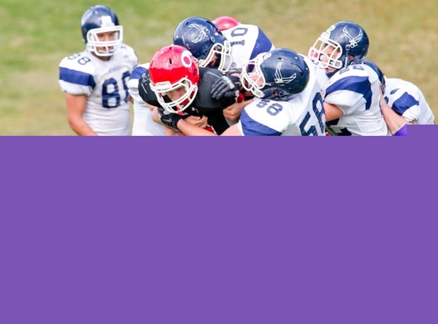 An Onteora (Boiceville, N.Y.) ballcarrier is swarmed by a host of Stissing Mountain (Pine Plains, N.Y.) players.