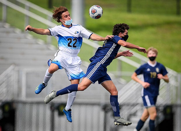A Lakeland (left) and Stoney Creek player go airborne while battling for the ball during a game in Michigan.