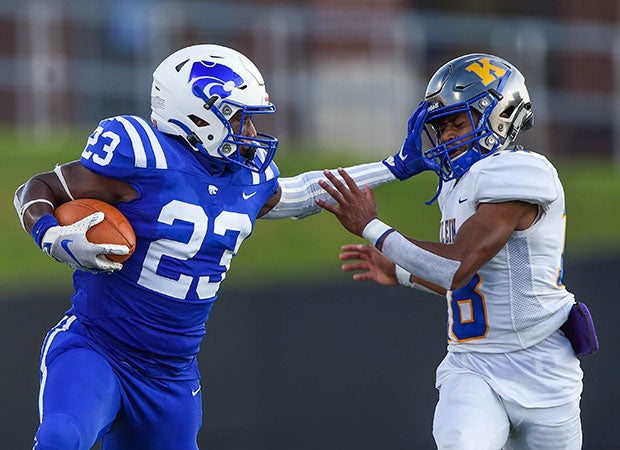 Cypress Creek (Texas) running back Omarie Simmons stiff-arms Klein defensive back Korey Celstine near the end of a pass completion at Pridgeon Stadium.
