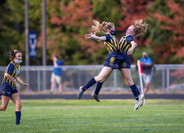 Isabella LaPerle (left) celebrates with her twin sister, Lyndsey, after scoring the eventual game-winning goal for Bow (N.H.) in a 2-1 victory over Hopkinton.