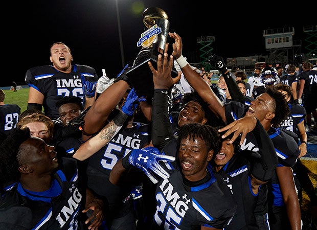 IMG players hoist the GEICO Bowl Series trophy.