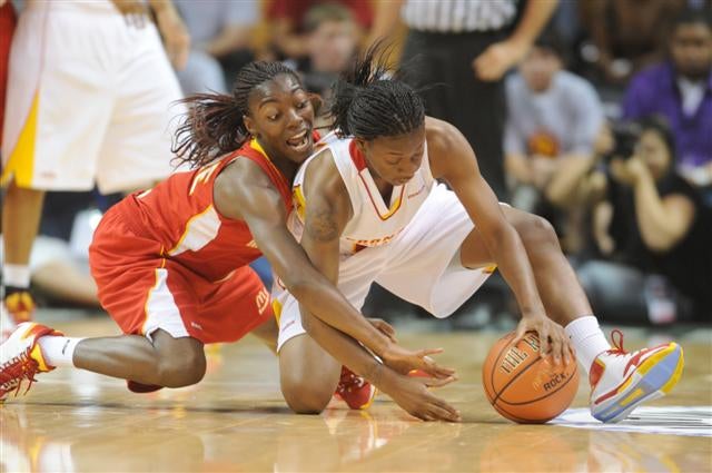 The game was as intense as this battle for loose ball by West's Eliza Pierre (left) and Erica Wheeler
