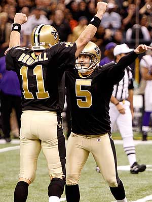 Kicker Hartley celebrates with holder Mark Brunell.