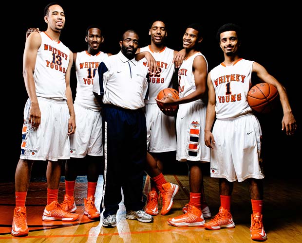 Whitney Young head coach Tyrone Slaughter is surrounded by players (left to right): Paul White, L.J. Peak, Jahlil Okafor, Miles Reynolds and Ausar Madison.  