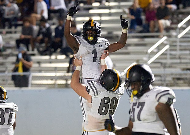 Lamar Patterson of St. Frances Academy celebrates after scoring a touchdown in the first half.