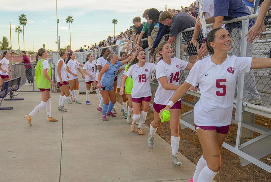 Perry players celebrate with fans after beating Pinnacle 3-2 for Arizona's Class 6A state title. The Pumas trailed 2-0 in the contest and had lost all five previous championship match appearances. (PHOTO: Chris Stanley)
