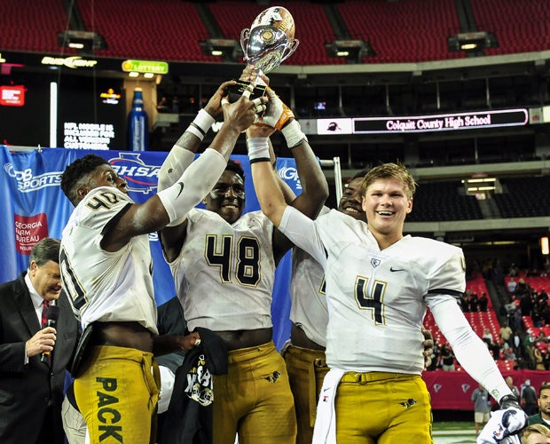 Colquitt County players proudly hoist the 6A championship trophy following their victory over Roswell.