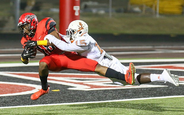Damarkus Lodge of Cedar Hill (Texas) goes in for the touchdown against Greg Peace of Bowie (Arlington, Texas).