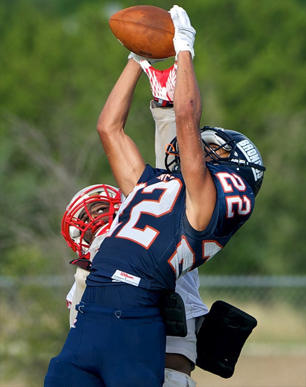 A JV player from Brandeis (San Antonio) goes up for the ball against a Judson (Converse, Texas) defender.
