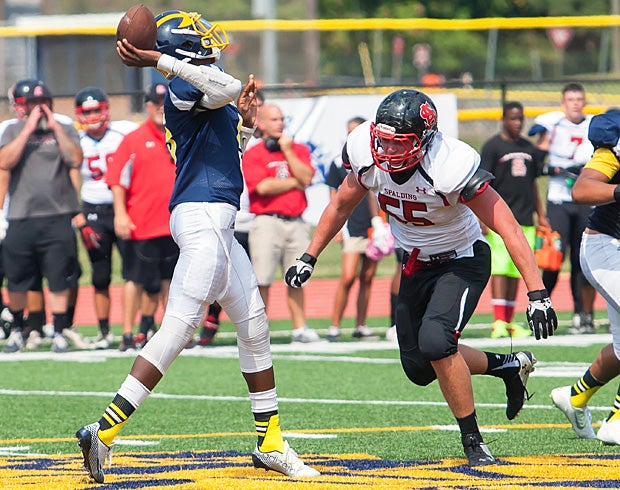 Sam Kouns of Archbishop Spalding (Severn, Md.) goes in for the sack against quarterback Amir Hall of Riverdale Baptist (Upper Marlboro, Md.).