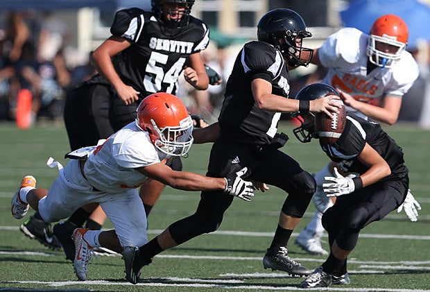A Bishop Gorman (Las Vegas) player goes for the sack in a freshman game against Servite (Anaheim, Calif.).