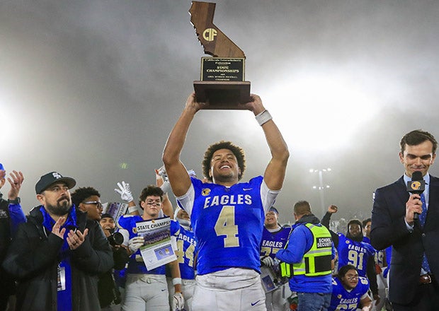 After heroic performances in two title games, Trent Mosley took a deserving turn lifting the state championship trophy. (PHOTO: Rene Morales)