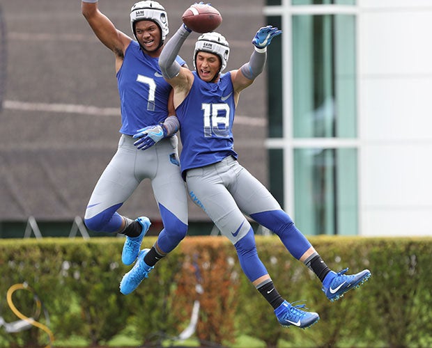 Nico Collins (left) and Oliver Martin may not liked putting on their soft-shell 40s-looking helmets, but they sure enjoyed celebrating this touchdown for Hypercool on Saturday.