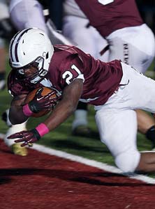 Elijah Ibitokun-Hanks dives into the end
zone for one of his three touchdowns.