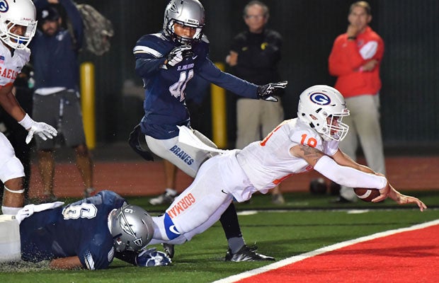 Tate Martell scores on an 18-yard touchdown keeper for the game's final touchdown to secure Bishop Gorman's 35-20 win over St. John Bosco on Friday night at Long Beach City College.