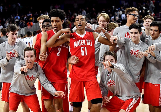 Mater Dei's Justice Sueing (2) and Harrison Butler (51) celebrate with teammates following their upset victory over Chino Hills on Friday night.