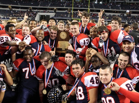 In the last football celebration of the season, Allen poses following its Texas 5A Division I over Lamar Saturday night at Cowboys Stadium. 