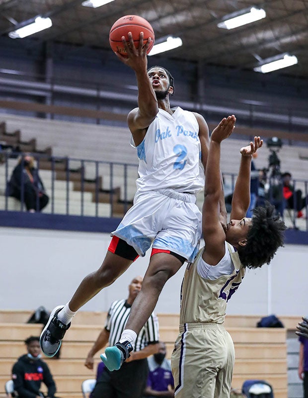 Oak Park's (Mo.) Cornelius Jones soars for a layup over a North Kansas City defender.