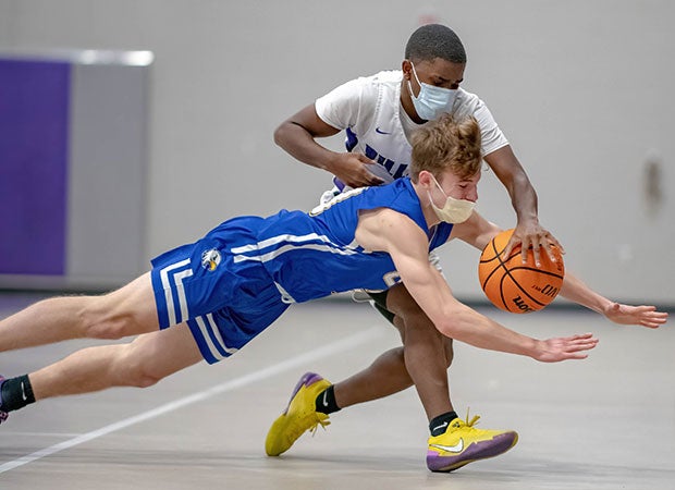 Tyler Henderson of Cape Fear Christian Academy (N.C.) dives for a steal against Myles Eakins of Village Christian Academy.