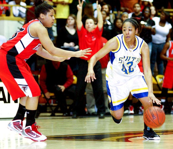 Olathe South's Natalie Knight (right) brings the ball up against a Wichita Heights defender.