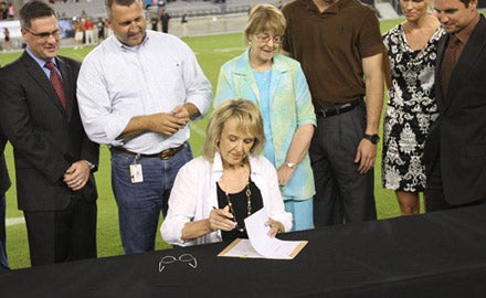 Arizona Gov. Jan Brewer signs history concussion legislation before Gorman-Chaparral game.