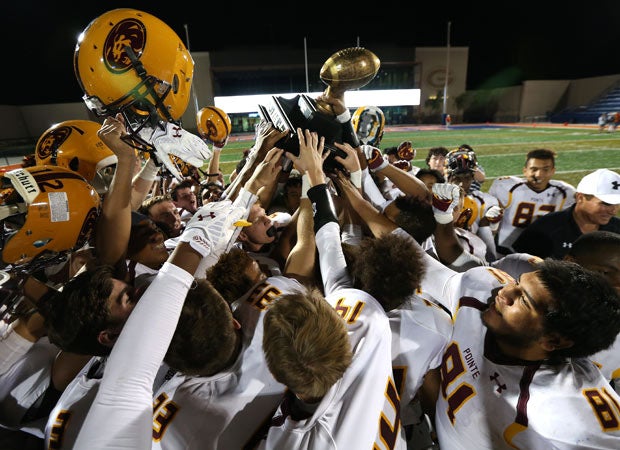 Mountain Pointe lifts the Barry Sollenberger trophy following a 66-13 victory over Reed (Nev.) in the Ninth Annual Sollenberger Classic at Bishop Gorman High School Saturday.