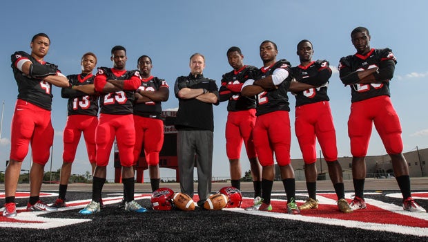 Head coach Joey McGuire (center) is surrounded by players (left to right): Richard Moore, Justin McMillan, Denvre Daniels, Randy Crystian, Damarkus Lodge, Demarcie Perry, Darrell Miller and Aca'cedric Ware.